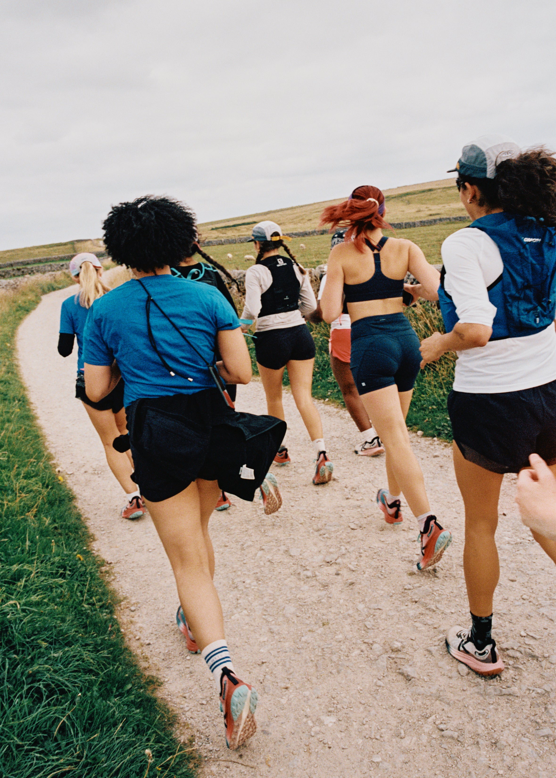 A group of women running in seek trail running shoes. 