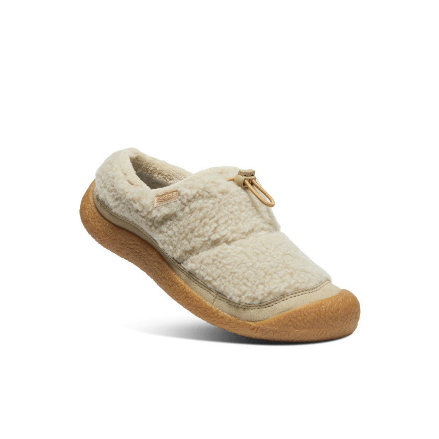 Cream shearling slip-on clog with toggle pull, angled side view