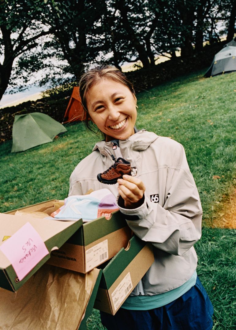 Person holding a mini Keen Targhee IV boot keychain. 