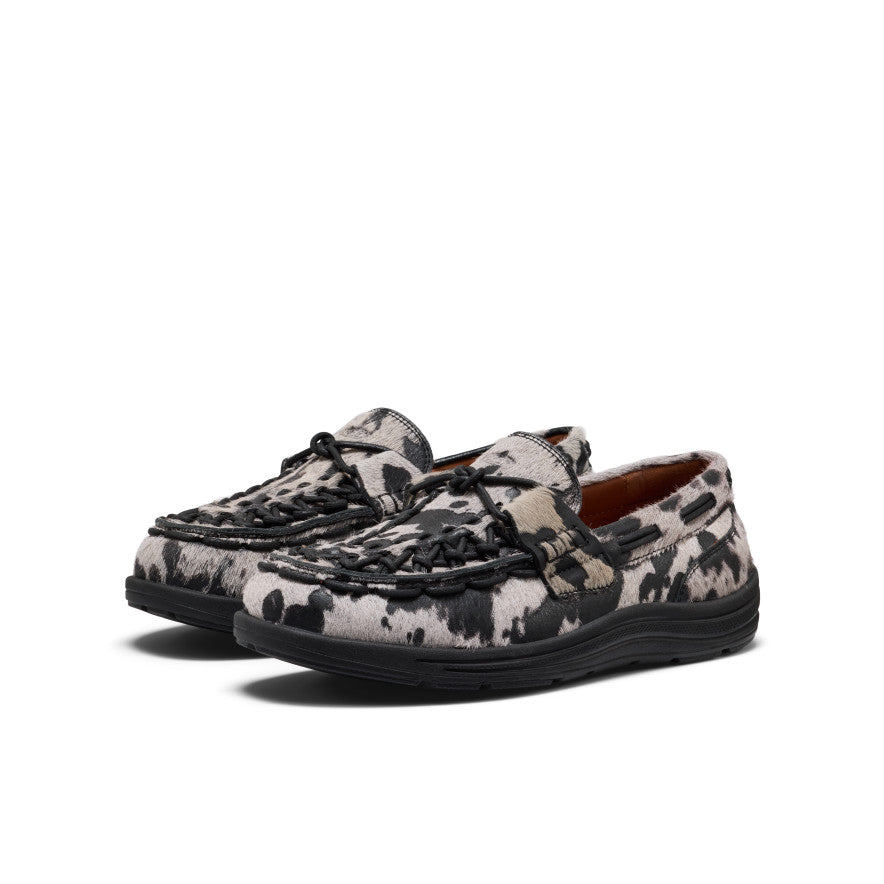 Women’s UNEEK loafer in nocturnal cow black featuring black and white cowhide pattern with braided black laces