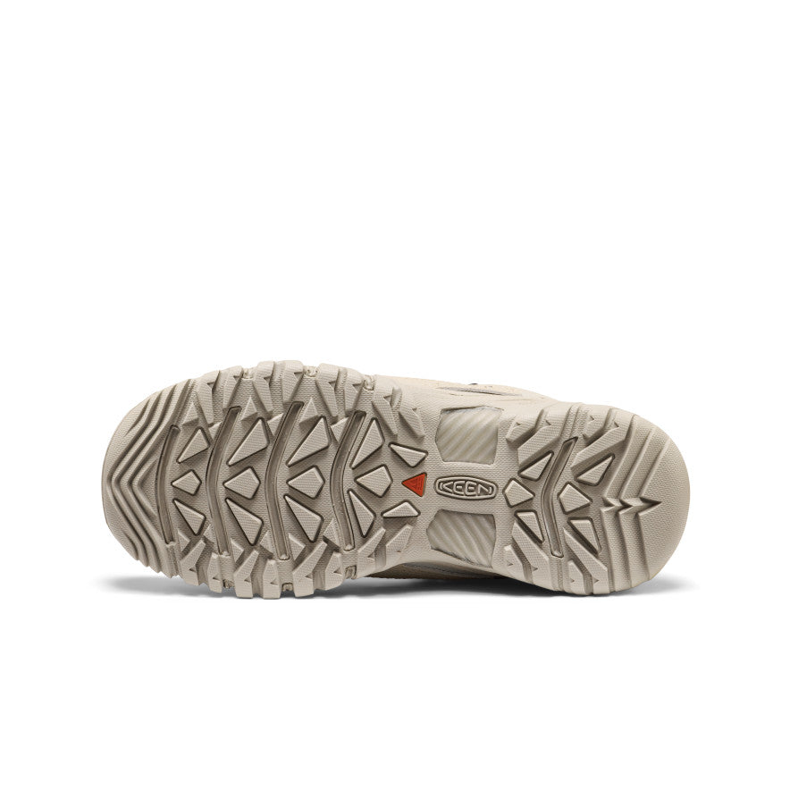 Beige keen women’s targhee exp waterproof hiking boot sole with rugged triangular tread and orange brand logo accent