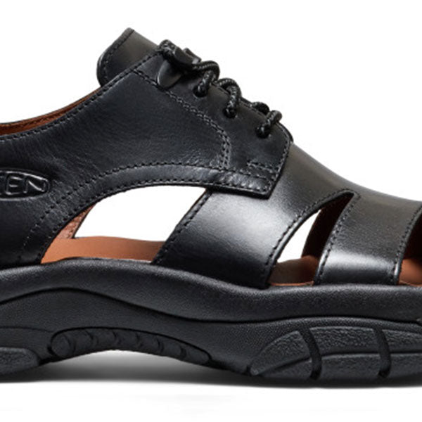 A close-up side view of a Keen black oxford shoe with a thick black sole, lace-up front, and cutout straps, shown against a plain white background.