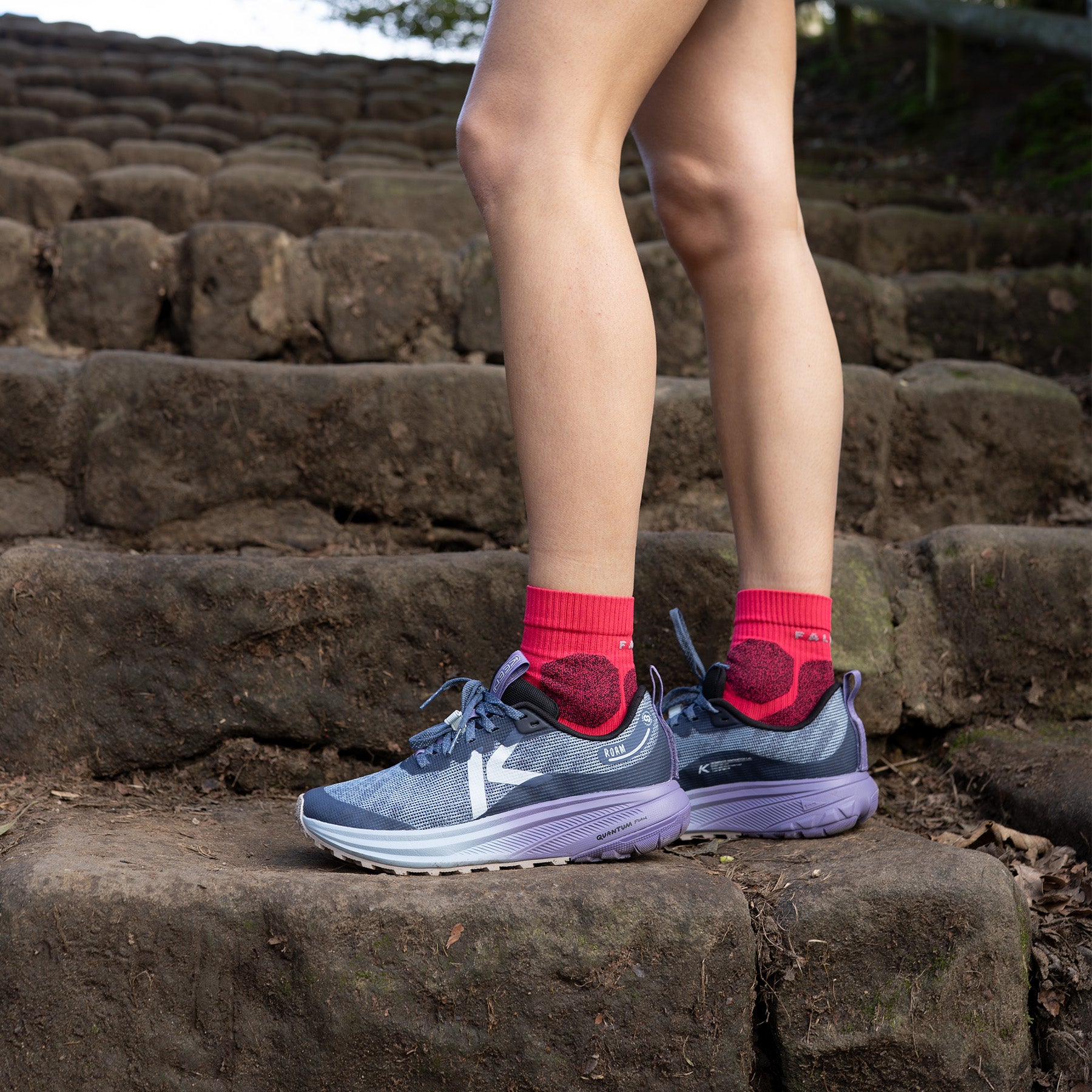Person wearing Roam Trail Running Shoes on a stone surface