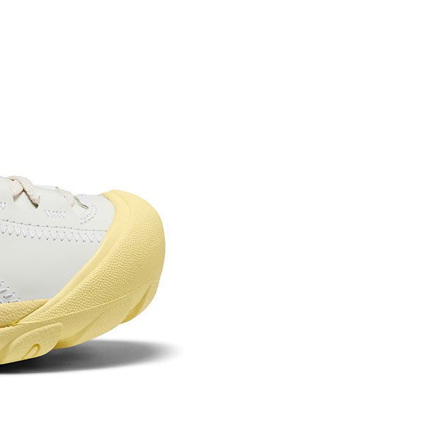 Close-up of the toe-box of the White Phileo x Keen collab shoe with a yellow sole on a white background